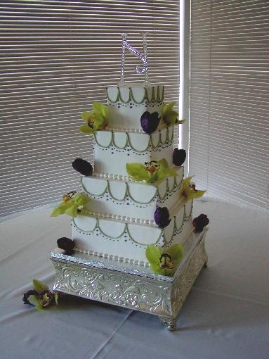 Gorgeous four tier square white wedding cake with exotic green orchids and 